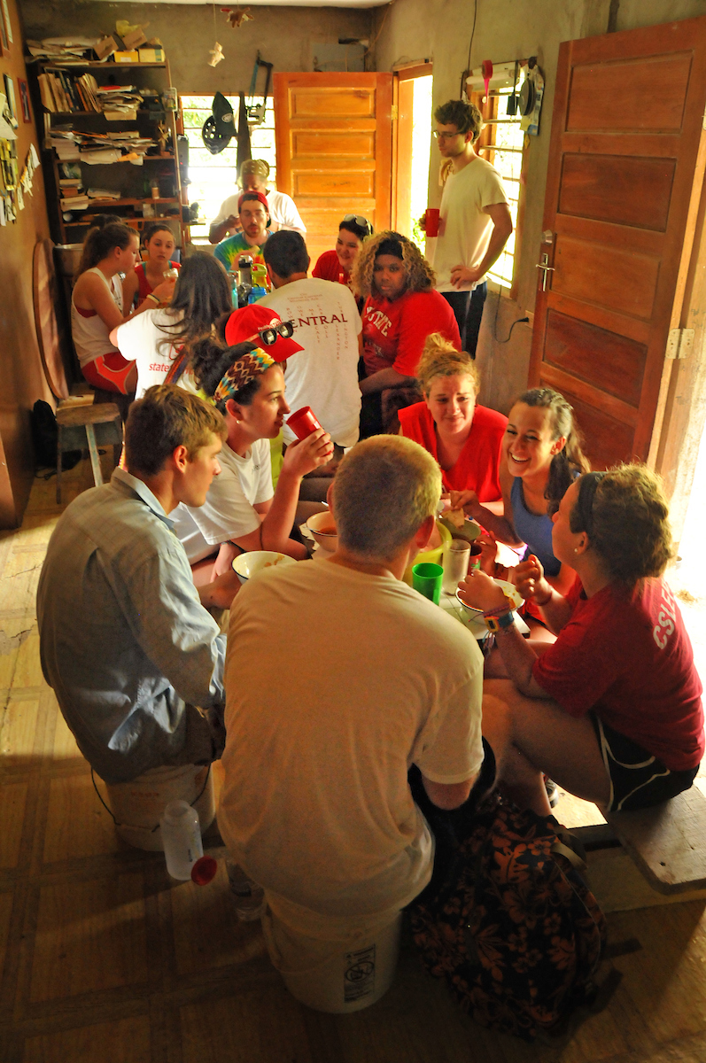Team Belize enjoys lunch at a neighbor's home in San Antonio.
