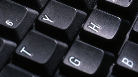 A close-up of a keyboard showing the letters 'T', 'Y', 'G', and 'H'