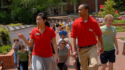 University Ambassadors Heather Chang (left) and John York lead a campus tour for prospective students and their parents.