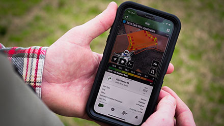 Archie Griffin uses a cell phone to monitor his fields.